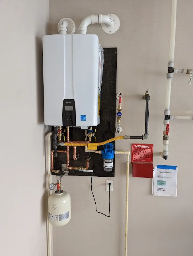 Professional plumber installing copper piping in a Cinco Ranch home